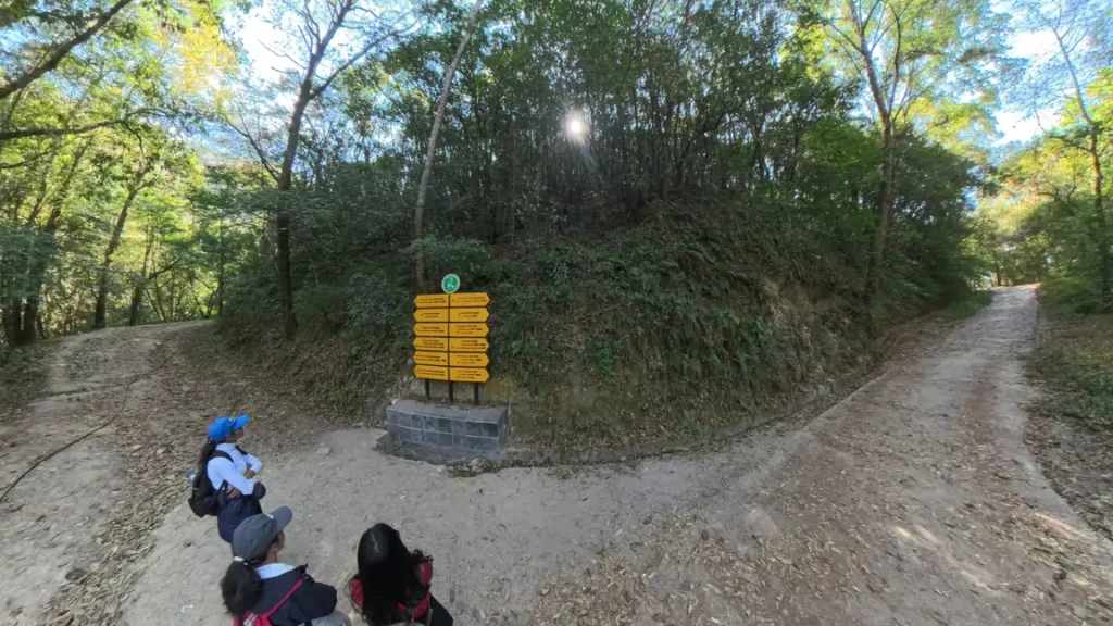 Path leading to Nagi Gumba with a direction board indicating the way