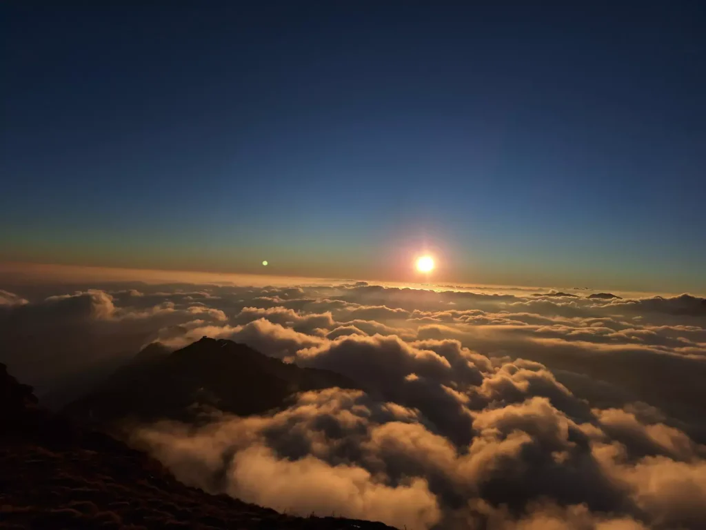 Layered clouds glowing in the evening sky during sunset on Mardi trek