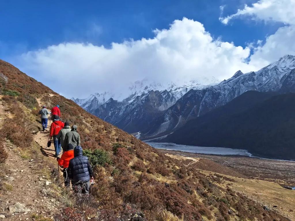 Trekker walking along a scenic mountain trail in Langtang Valley surrounded by nature